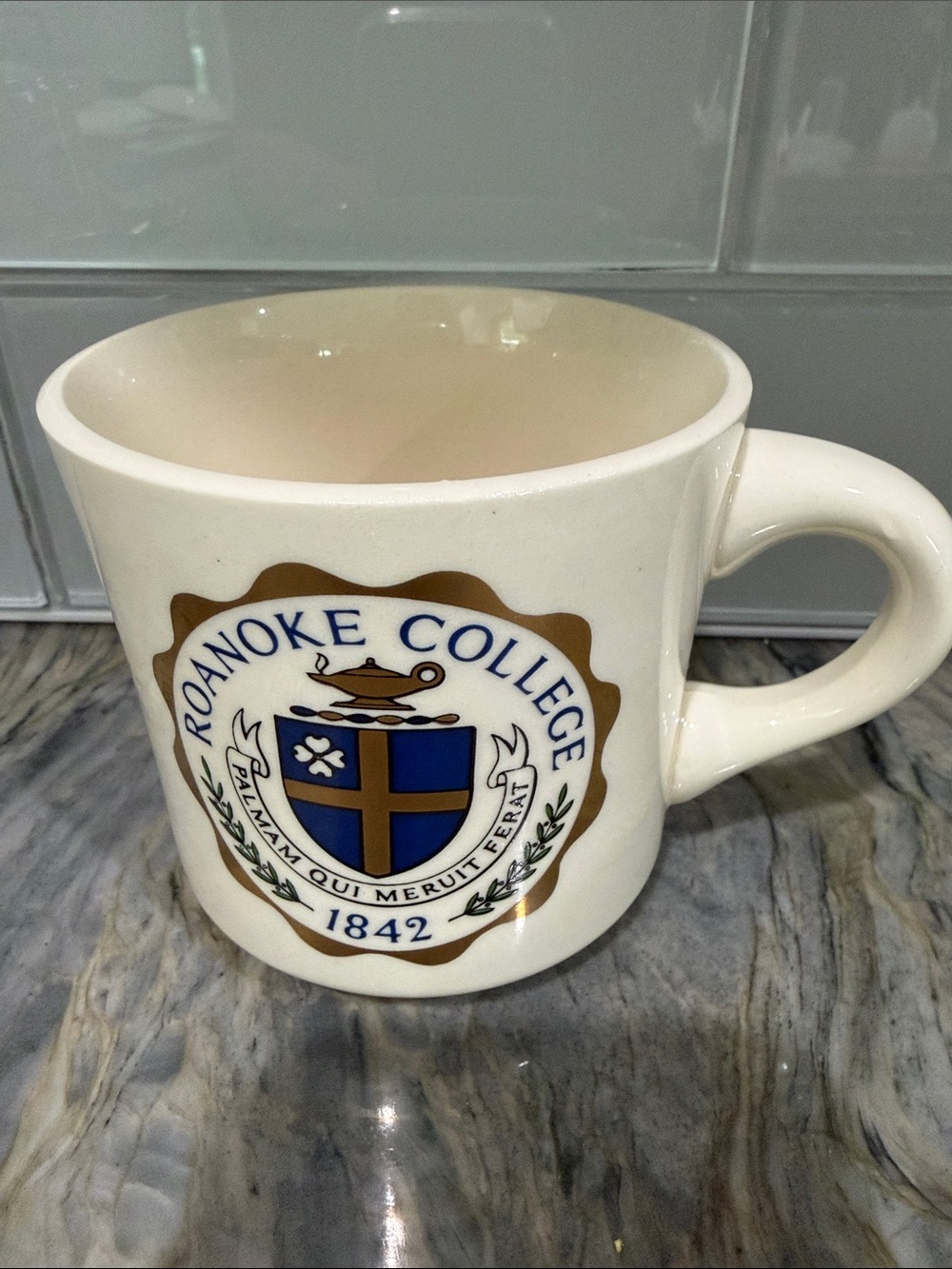 Roanoke College Cream Ceramic Mug with Blue and Gold Crest
